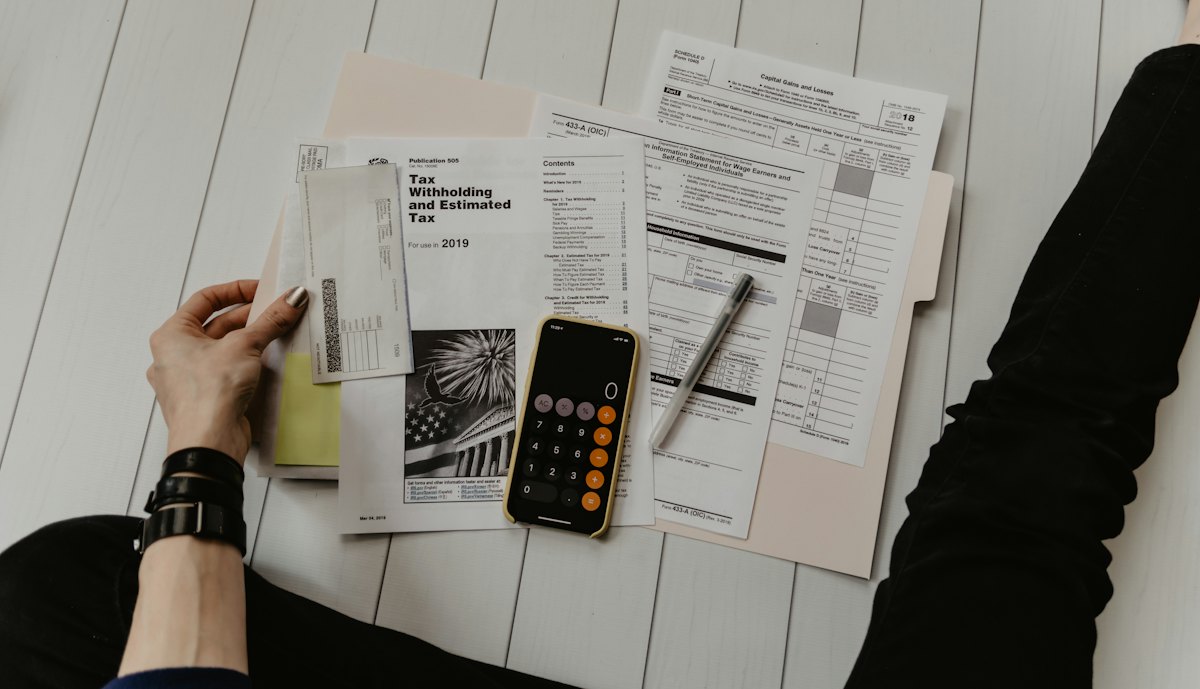 Accountant reviewing financial documents with a calculator